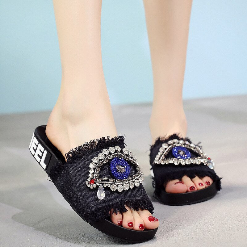 Black Evil eyes decorate slides shoes