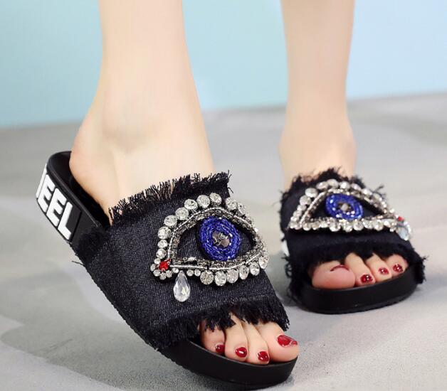 Black Evil eyes decorate slides shoes
